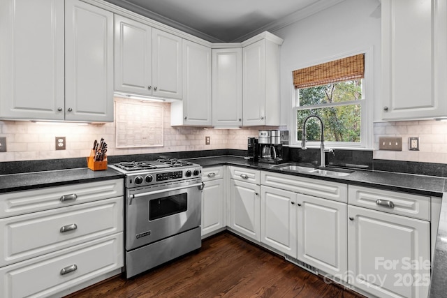 kitchen with dark hardwood / wood-style floors, tasteful backsplash, sink, white cabinets, and gas stove