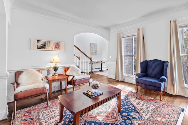 living room with crown molding, hardwood / wood-style flooring, and a wealth of natural light