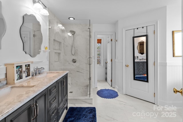 bathroom featuring vanity and a shower with shower door