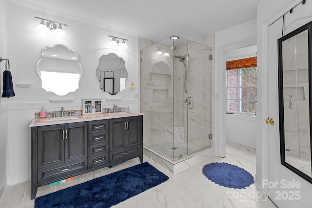 bathroom featuring walk in shower and vanity