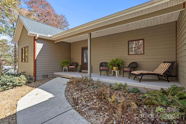 view of exterior entry with a patio