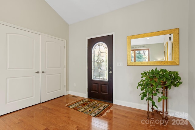 entryway with hardwood / wood-style flooring and lofted ceiling