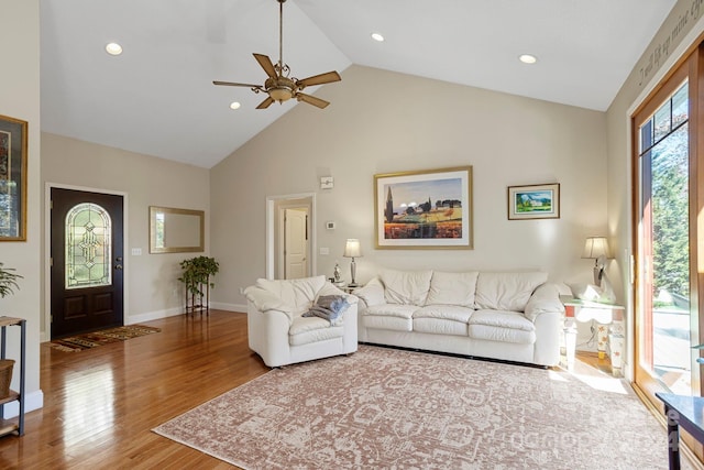 living room with hardwood / wood-style flooring, high vaulted ceiling, and ceiling fan