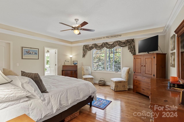 bedroom with crown molding, wood-type flooring, and ceiling fan