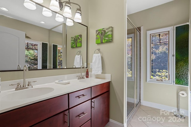 bathroom with vanity, a shower with shower door, and tile patterned flooring