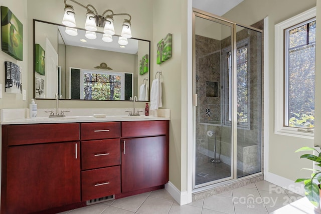 bathroom with vanity, tile patterned floors, a shower with shower door, and plenty of natural light