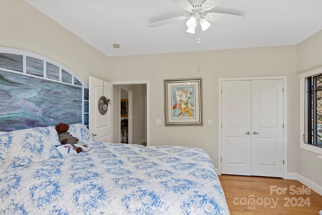 bedroom featuring wood-type flooring, a closet, and ceiling fan