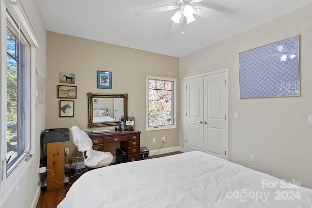 bedroom with dark hardwood / wood-style flooring, a closet, and ceiling fan