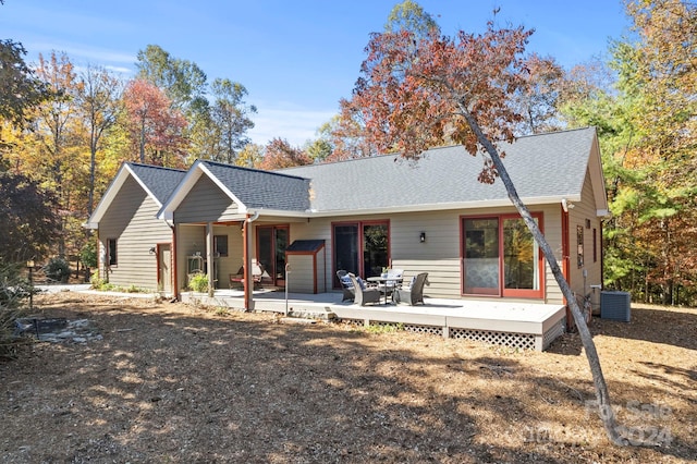 view of front of home with a deck, a patio, and central AC unit