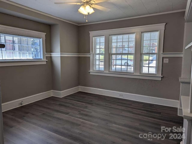 spare room featuring dark hardwood / wood-style floors, ceiling fan, and crown molding