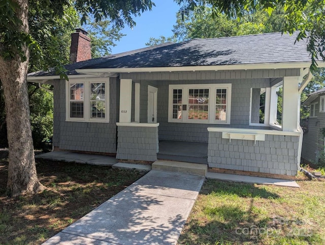602 W Council St, Salisbury, NC 28144 - view of front of house featuring a porch, a chimney, and a shingled roof