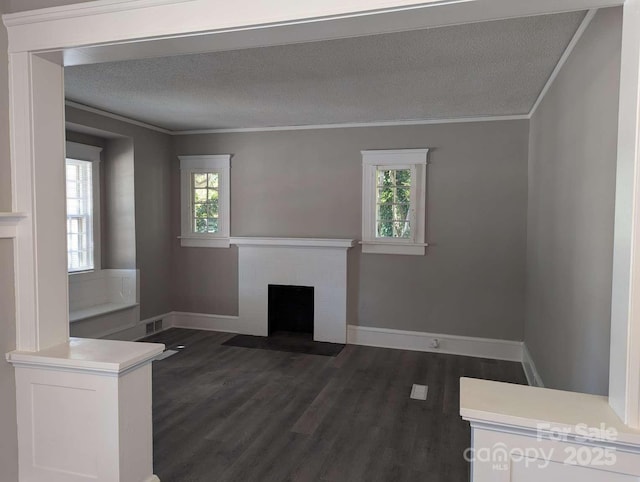 602 W Council St, Salisbury, NC 28144 - unfurnished living room featuring ornamental molding, a brick fireplace, dark wood finished floors, and a textured ceiling