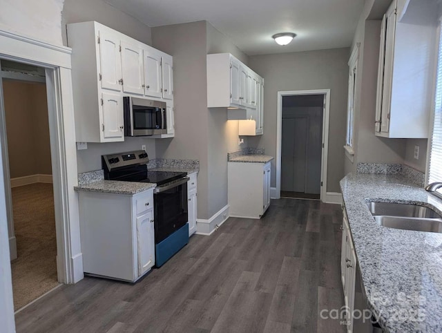 602 W Council St, Salisbury, NC 28144 - kitchen featuring stainless steel appliances, dark wood finished floors, white cabinets, and light stone counters