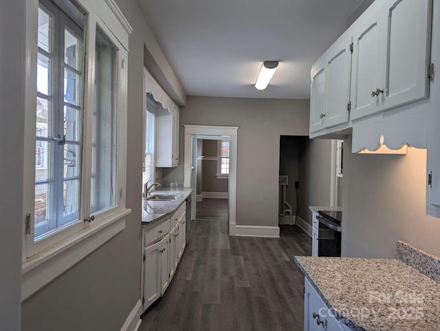 602 W Council St, Salisbury, NC 28144 - kitchen with white cabinetry, dark wood-style floors, light stone counters, and electric range oven