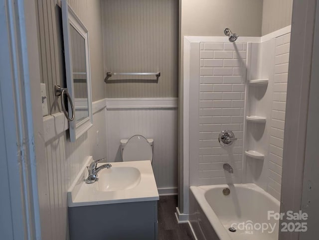 602 W Council St, Salisbury, NC 28144 - bathroom featuring a wainscoted wall, bathing tub / shower combination, wood finished floors, and vanity
