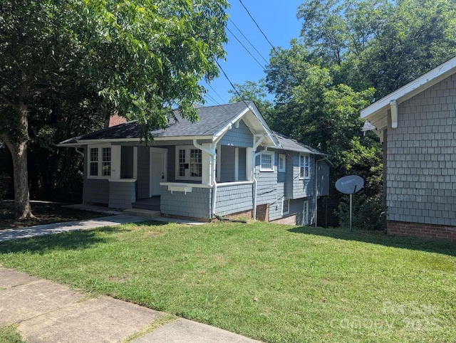 602 W Council St, Salisbury, NC 28144 - view of front facade with a front yard, a shingled roof, and a chimney