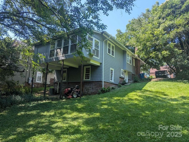 602 W Council St, Salisbury, NC 28144 - back of house featuring a yard, a chimney, cooling unit, and a sunroom