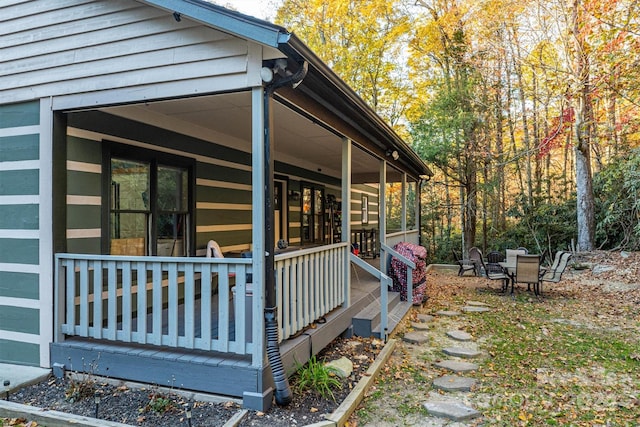 view of side of home with a porch