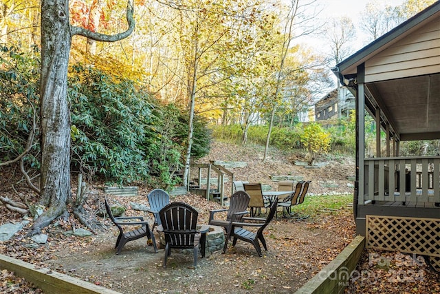 view of yard with an outdoor fire pit and a wooden deck