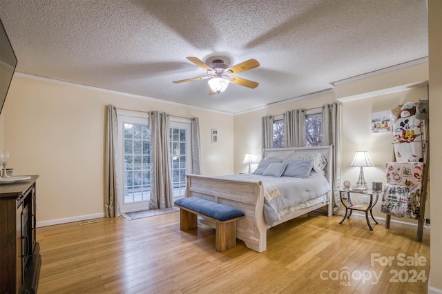 bedroom with ceiling fan, a textured ceiling, access to exterior, light hardwood / wood-style floors, and crown molding