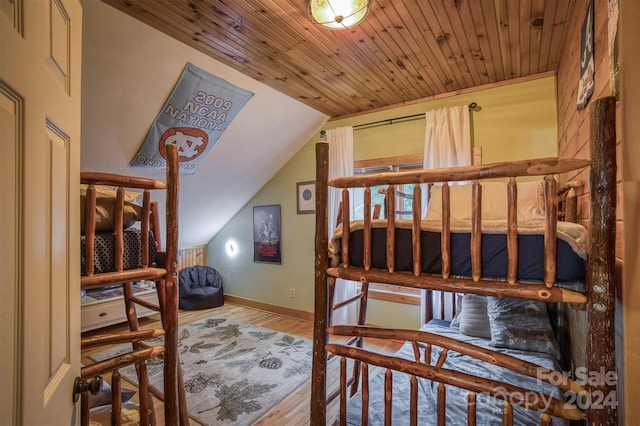 bedroom featuring lofted ceiling, hardwood / wood-style floors, and wood ceiling