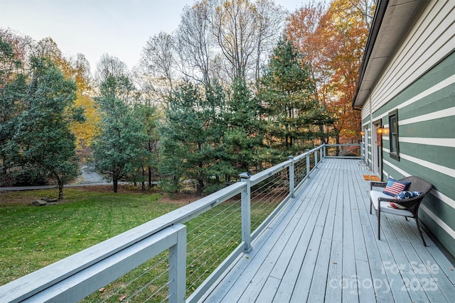 wooden terrace featuring a lawn