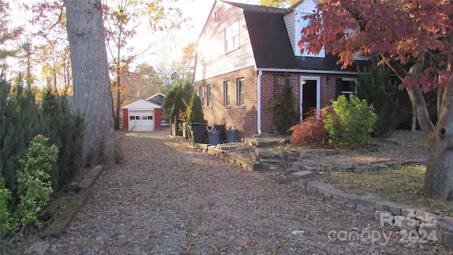 view of side of property featuring an outbuilding and a garage