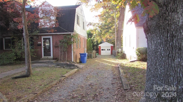 view of side of home featuring a garage, an outbuilding, and central AC unit