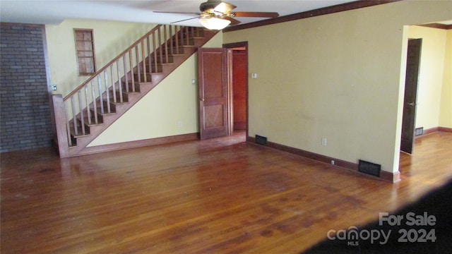 unfurnished living room with ornamental molding, wood-type flooring, and ceiling fan