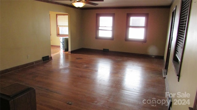 spare room with dark hardwood / wood-style floors and ceiling fan