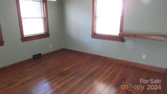 unfurnished room with dark hardwood / wood-style floors