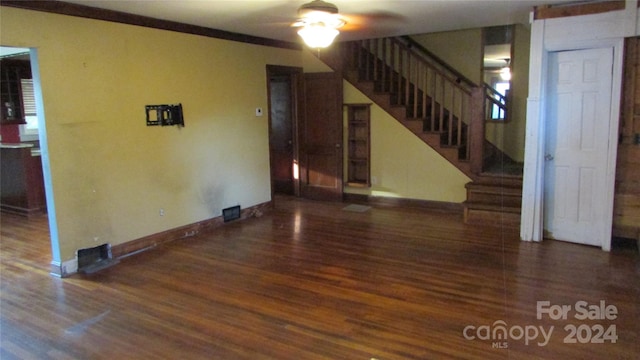 empty room featuring ornamental molding, ceiling fan, and dark hardwood / wood-style flooring