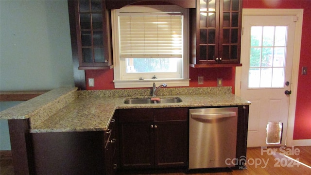 kitchen with sink, light hardwood / wood-style flooring, dishwasher, and light stone counters