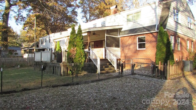 back of property with central AC, ceiling fan, and a sunroom