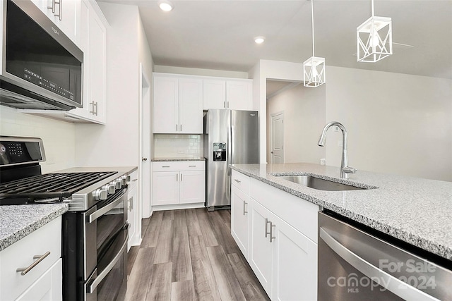 kitchen with stainless steel appliances, sink, and white cabinets