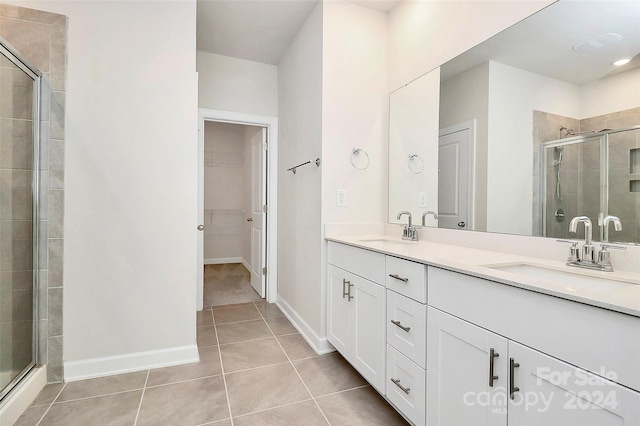 bathroom with vanity, tile patterned flooring, and an enclosed shower