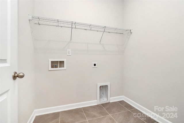 clothes washing area featuring hookup for an electric dryer, hookup for a washing machine, and tile patterned flooring