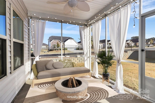 sunroom featuring ceiling fan and wooden ceiling