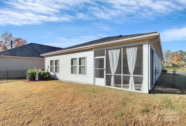 rear view of house featuring a lawn