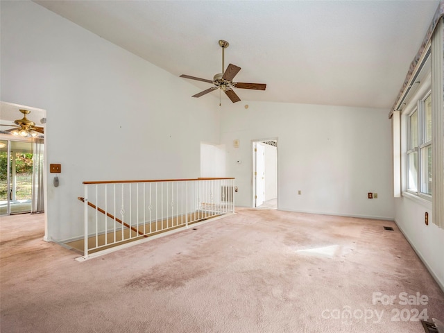 carpeted spare room with high vaulted ceiling and ceiling fan