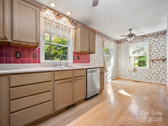 kitchen featuring sink, dishwasher, a textured ceiling, ceiling fan, and light hardwood / wood-style floors