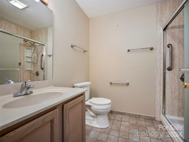 bathroom with a textured ceiling, walk in shower, toilet, vanity, and tile patterned flooring