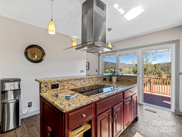 kitchen with black electric stovetop, island exhaust hood, dark wood-type flooring, hanging light fixtures, and a textured ceiling