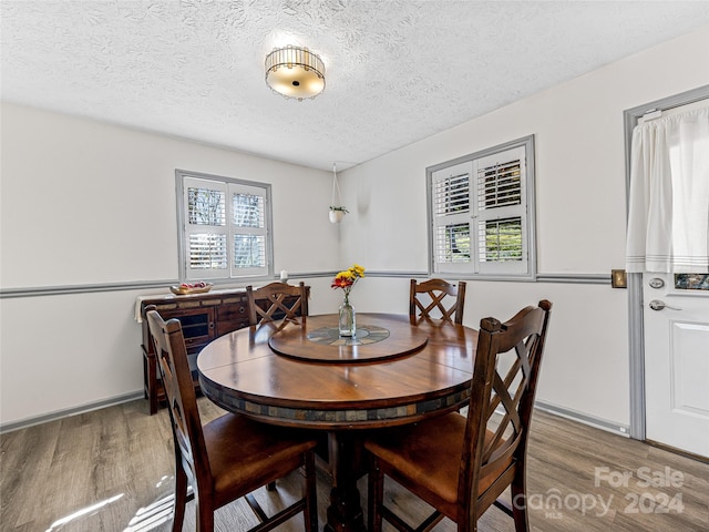 dining area with a textured ceiling and a healthy amount of sunlight