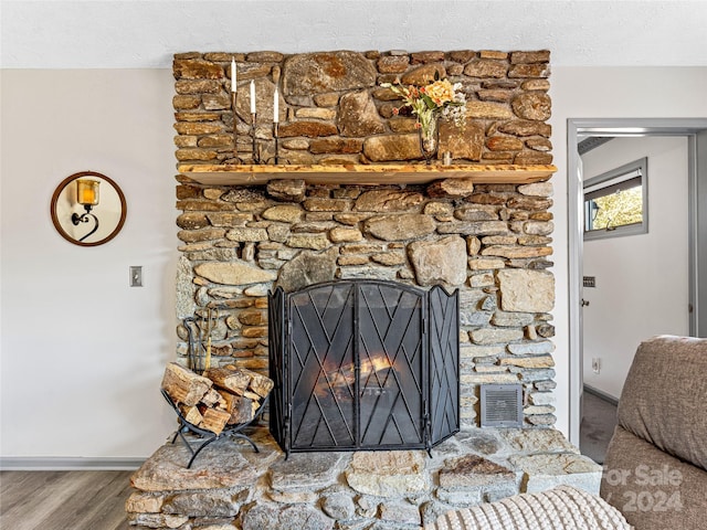 interior details featuring wood-type flooring and a fireplace