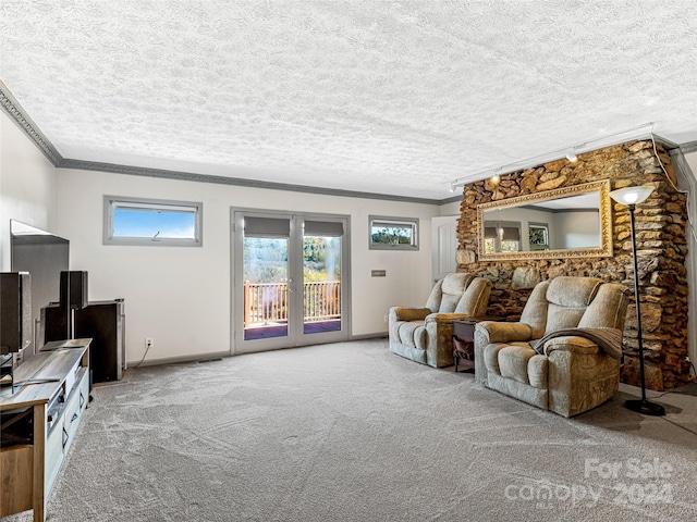 living room featuring crown molding, a textured ceiling, and carpet floors