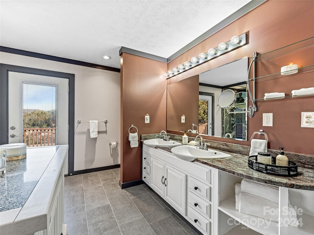 bathroom featuring vanity, a textured ceiling, and a healthy amount of sunlight