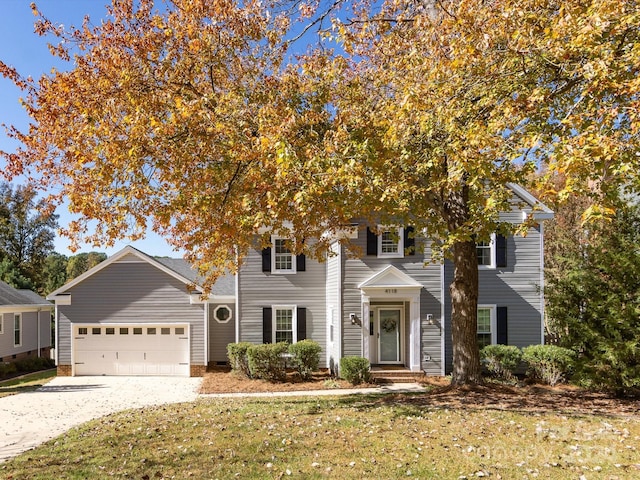 view of front facade featuring a front yard and a garage