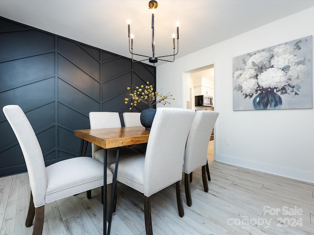 dining room featuring light hardwood / wood-style floors and a chandelier