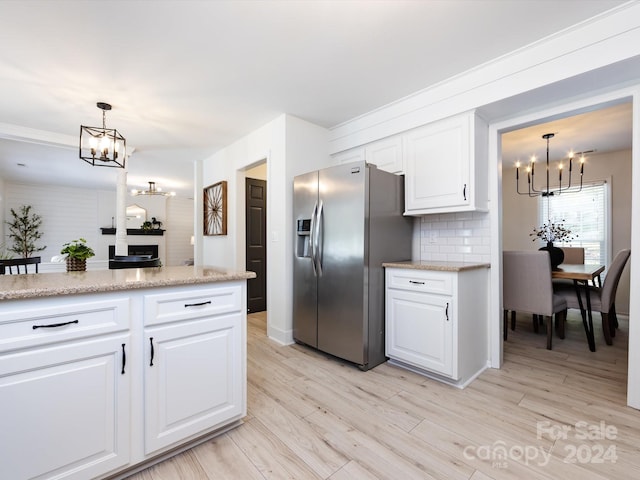 kitchen featuring white cabinets, light hardwood / wood-style flooring, decorative light fixtures, and stainless steel refrigerator with ice dispenser